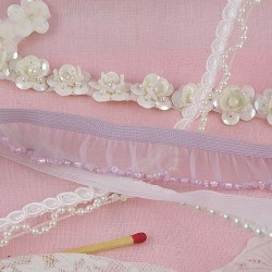 Pearls, glitter, sequins on ribbon.